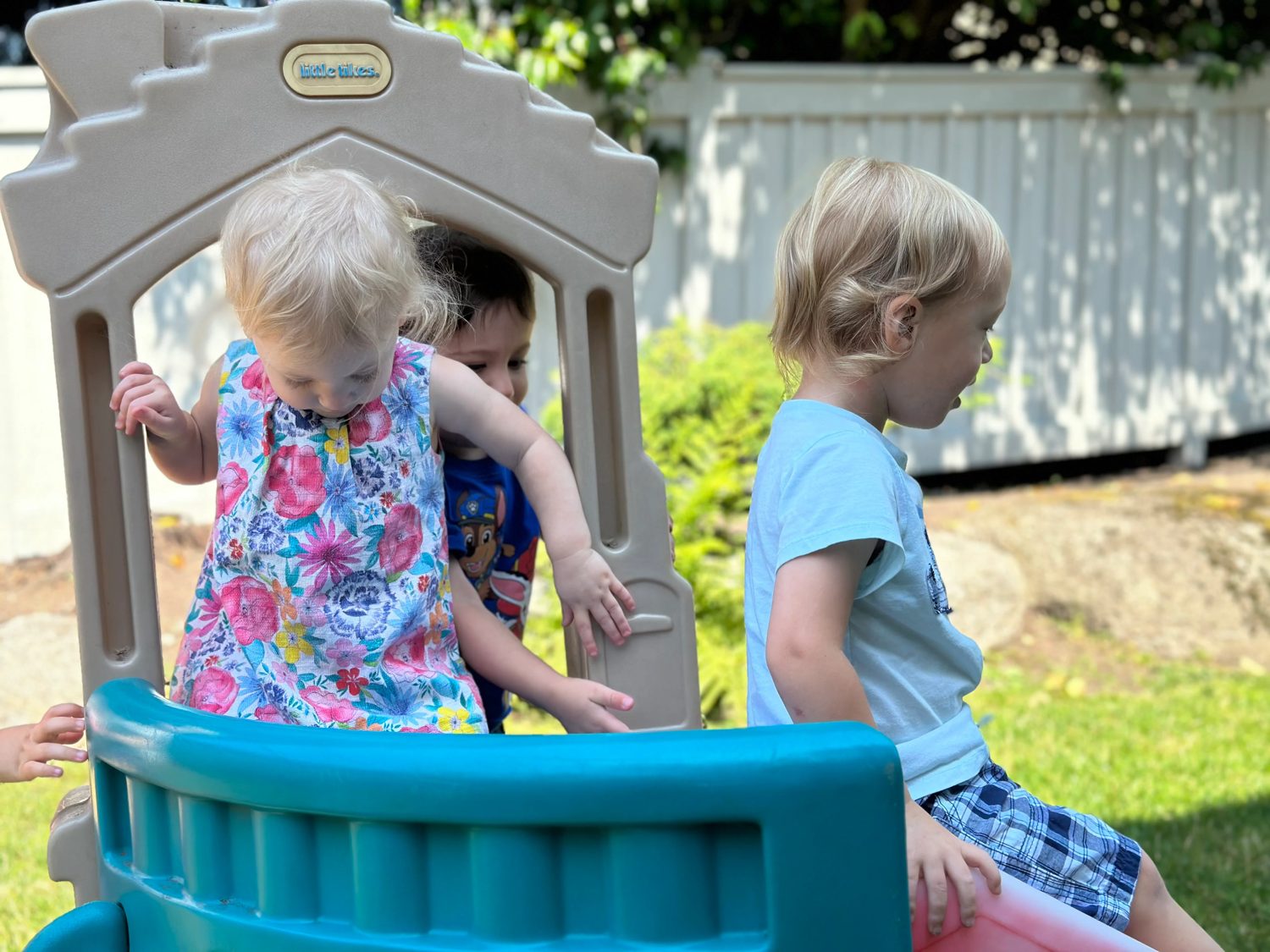 Children playing together on a backyard slide