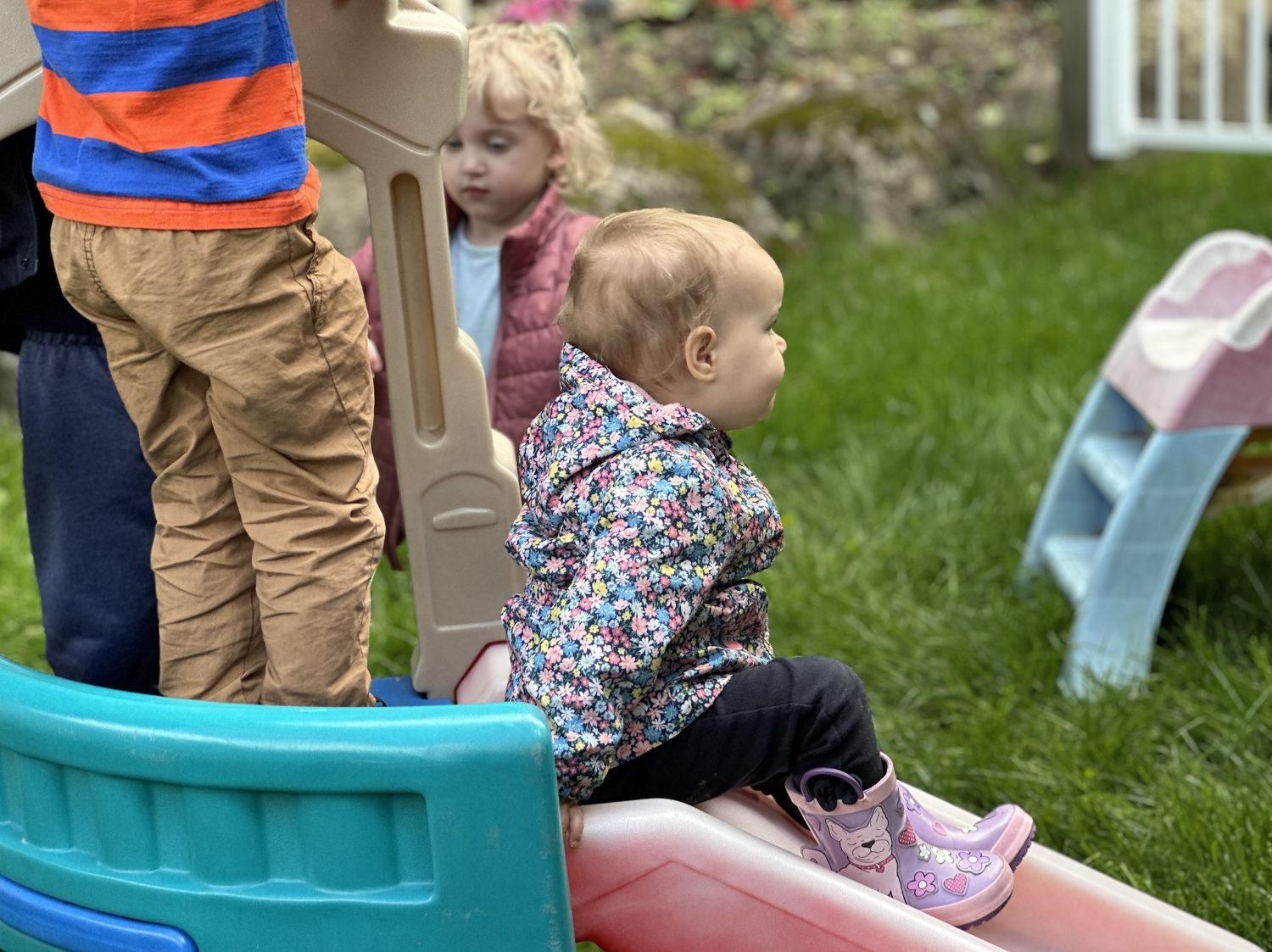 Children playing on a slide in the sunshine